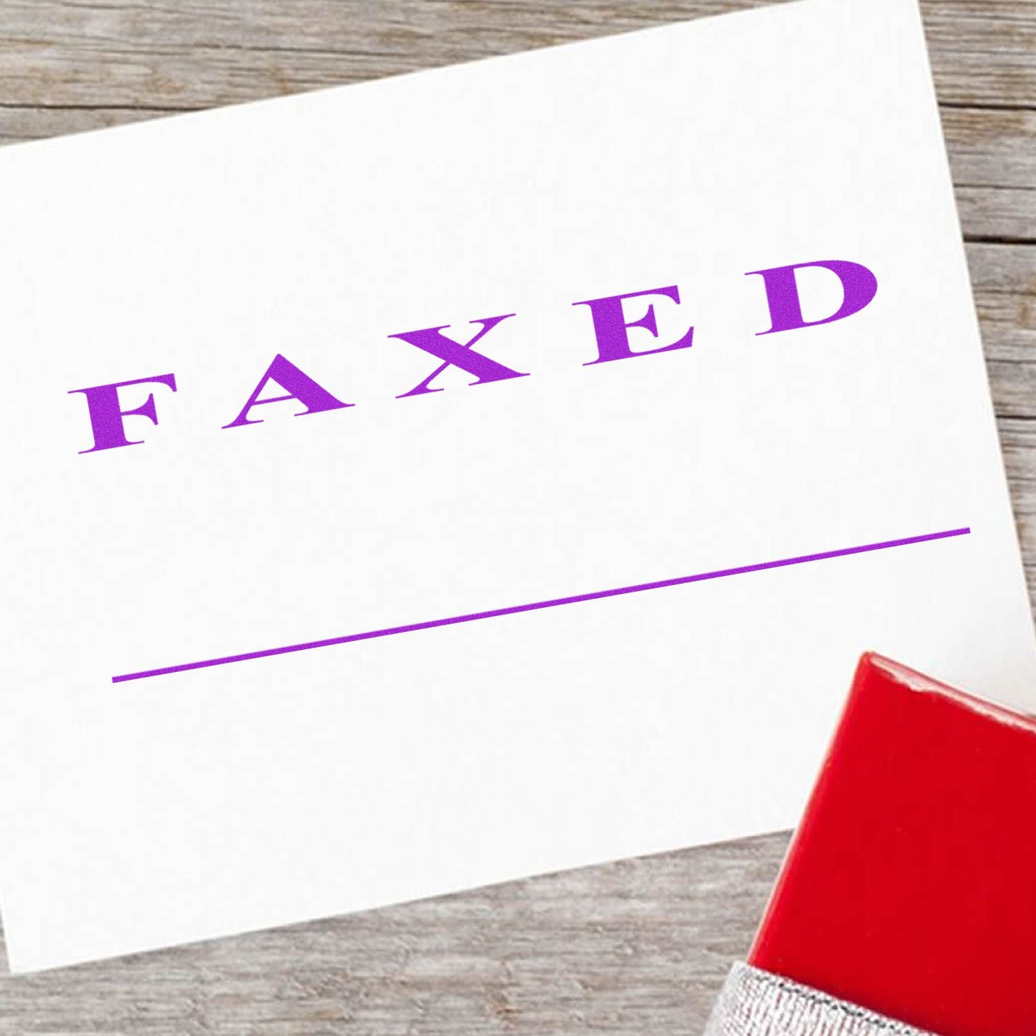 Faxed confirmation card with purple FAXED text and red stamp on wooden background