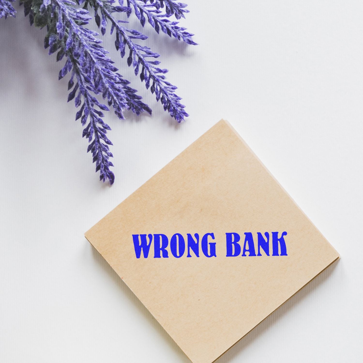 Wrong bank transfer concept with WRONG BANK text on a kraft envelope and purple feathers on a white background