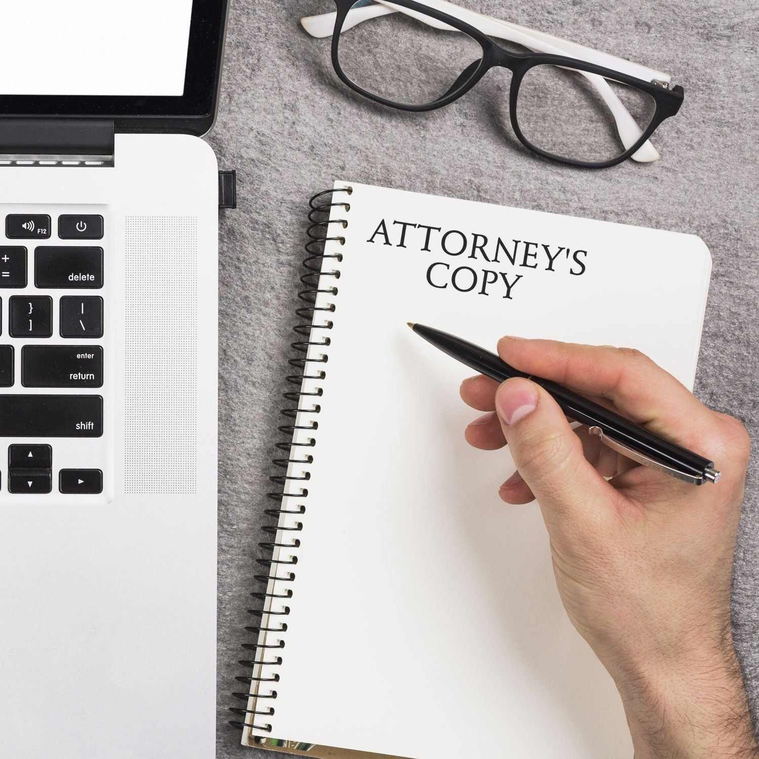 Attorneys copy notebook with pen, showing legal office writing beside calculator and keyboard for law firm documentation