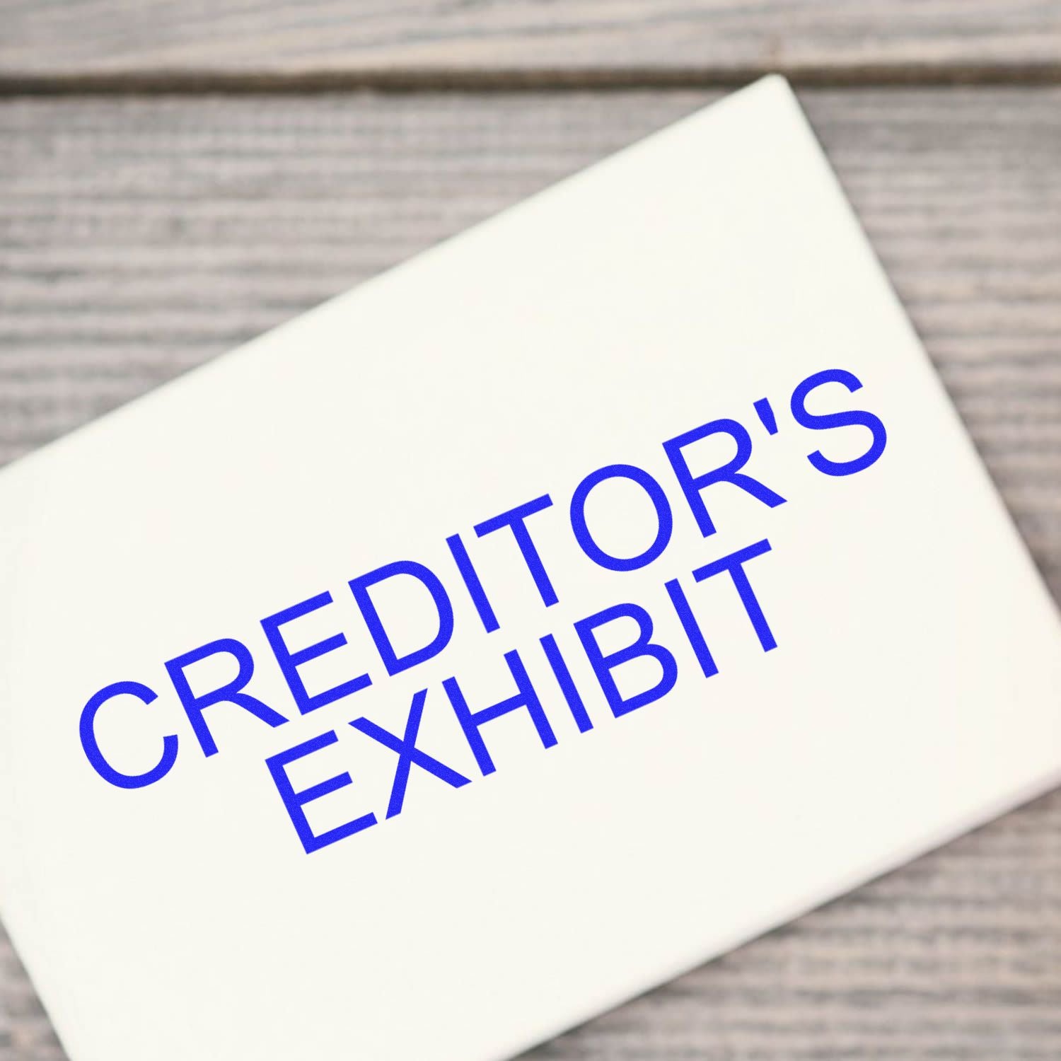 Close-up of a document titled Creditors Exhibit on a table, representing legal claims and creditor information.