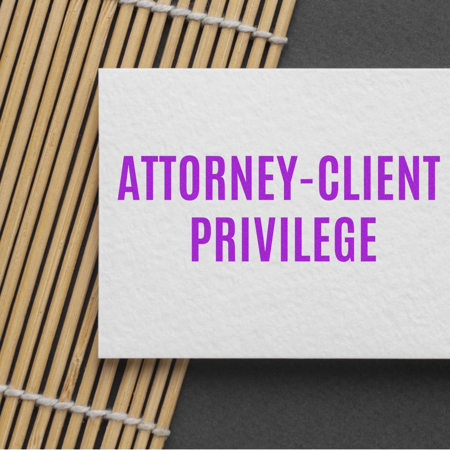 Attorney-client privilege text on white card, highlighting legal confidentiality and privileged communication in law practice, bamboo setting.