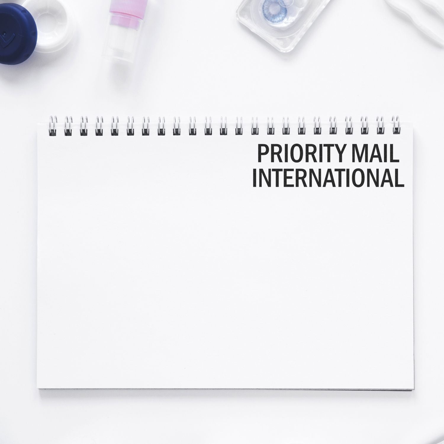 Priority Mail International notebook layout with shipping suppliespromotes fast global mail service for business correspondence.