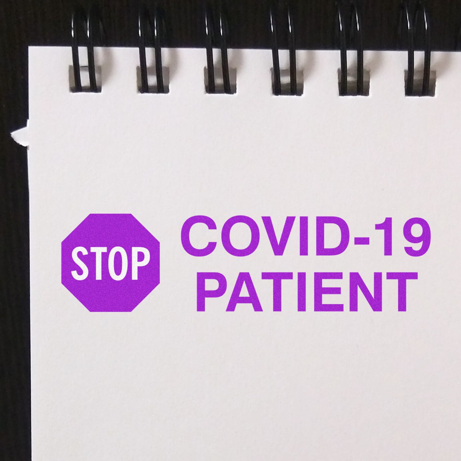 STOP COVID-19 PATIENT warning sign on door, advising contact precautions and infection control during COVID-19 in healthcare clinic.