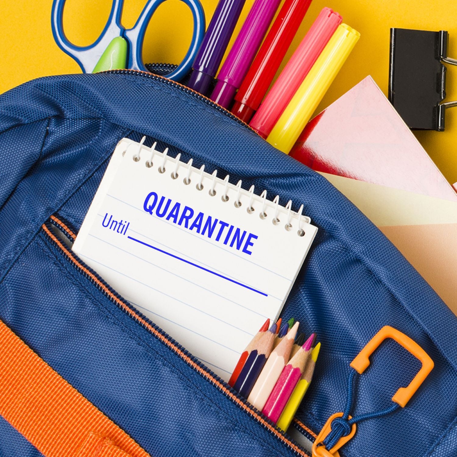Blue quarantine school supply pouch with notebook and colorful crayons, helping kids write and draw at home.