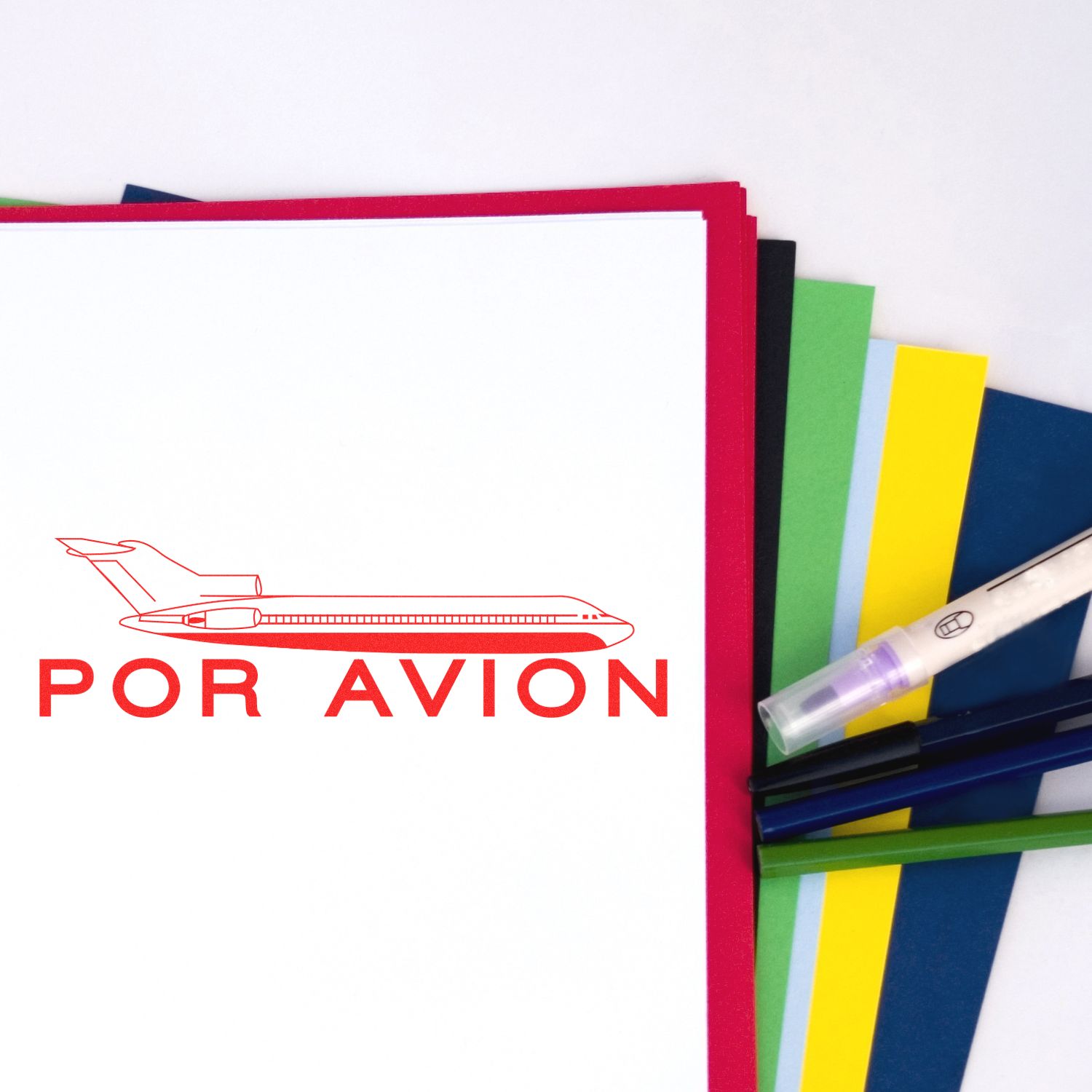 Stack of FOR AVION folders with airplane icon and colorful stationery, representing aviation-themed mail or travel documents.