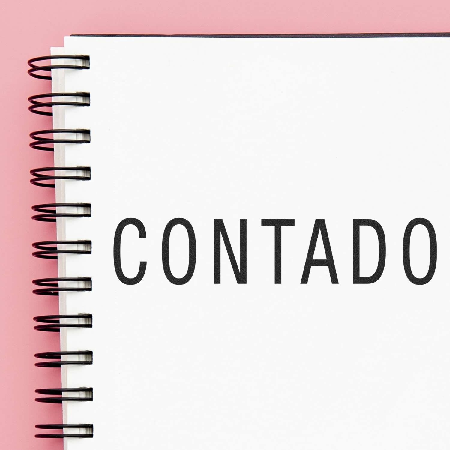 Contact concept image showing a spiral notebook binding with bold CONTACT text for business communication and outreach.