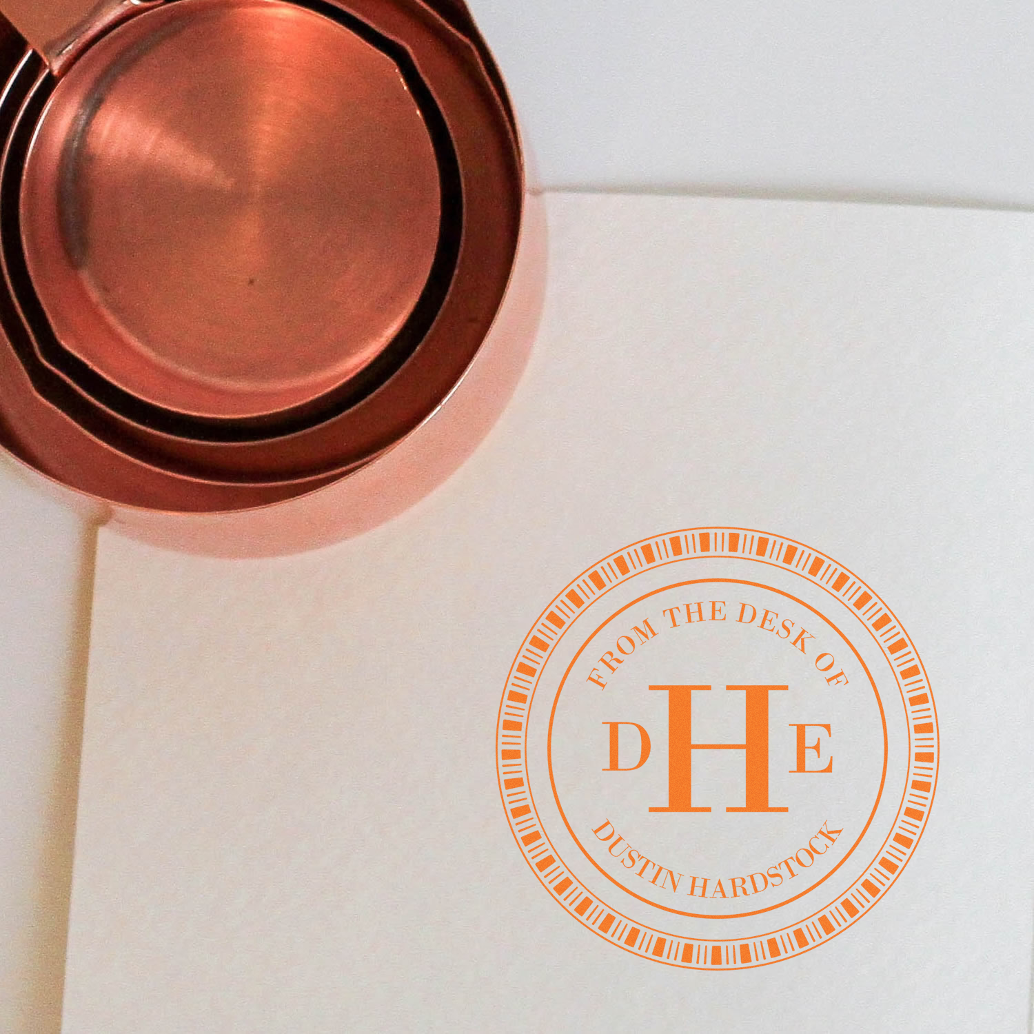 Personalized round rubber stamp with DHE monogram and From the Desk of Dustin Hardstock custom office stationery imprint.
