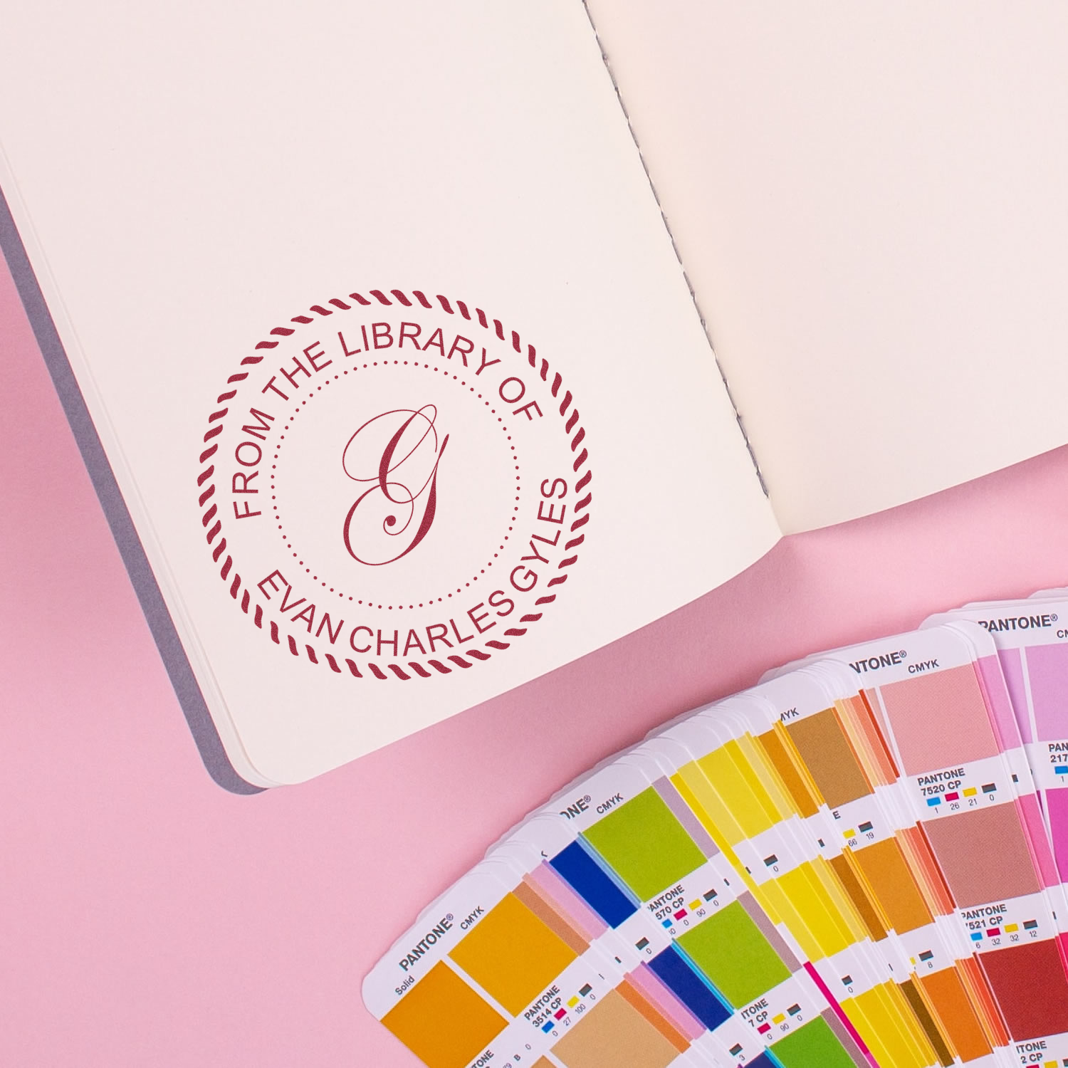 Custom rubber book stamp with monogram, reading From the Library of Evan Charles Gyles, for personalized stationery.