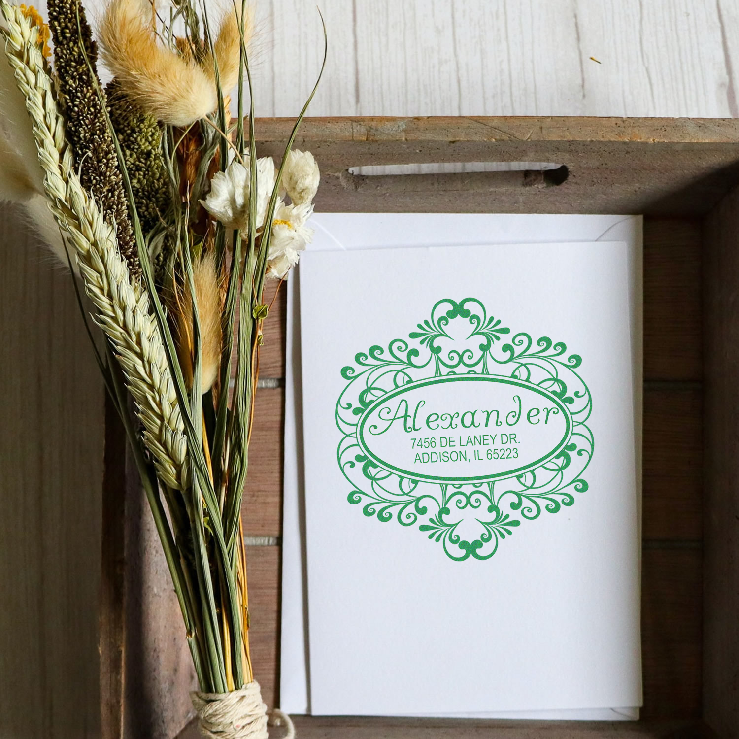 Custom floral return address rubber stamp on a wedding thank-you card with dried bouquet gift packaging