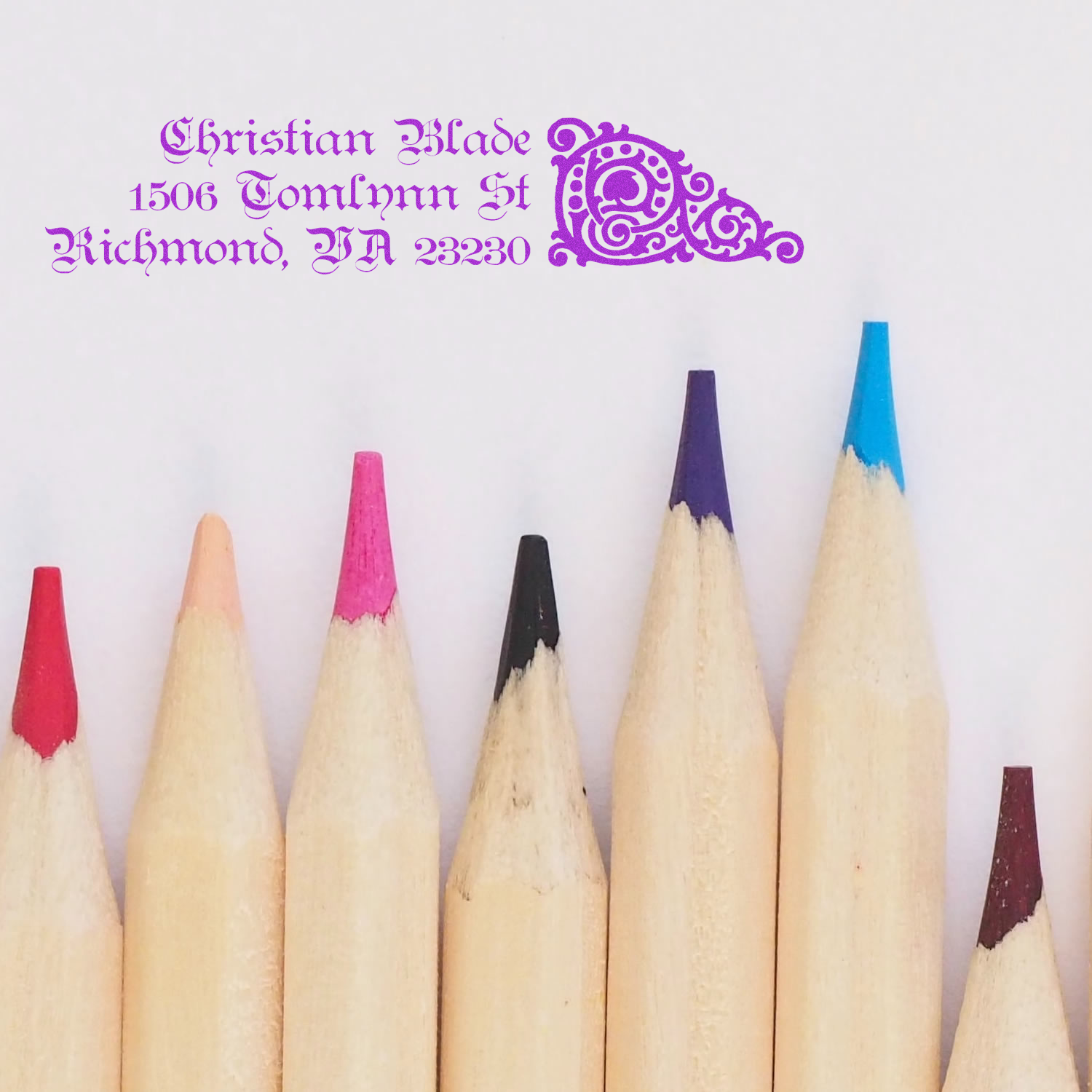 Personalized return address rubber stamp with ornate purple design for Christian Blade, 1506 Tomlyn St, Richmond, VA 23230.
