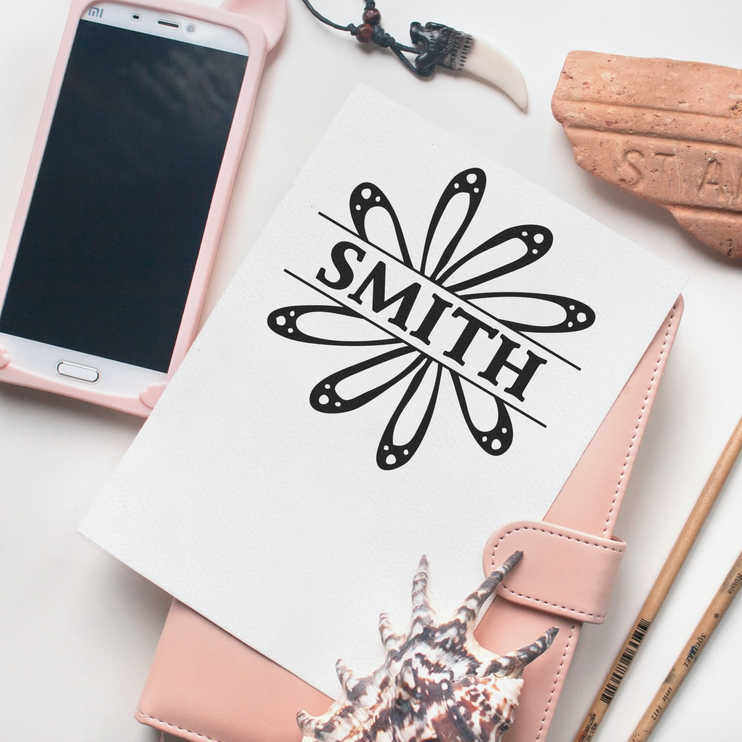 Flat lay of smartphone, pink wallet, and SMITH logo artwork, showcasing a branded lifestyle graphic design concept.