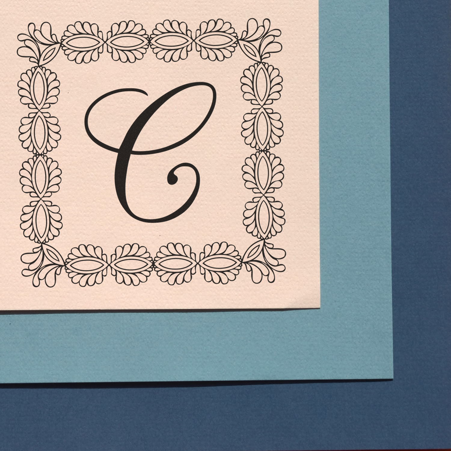 Custom floral monogram C rubber stamp with ornate botanical border for wedding invitations, stationery, and branding.