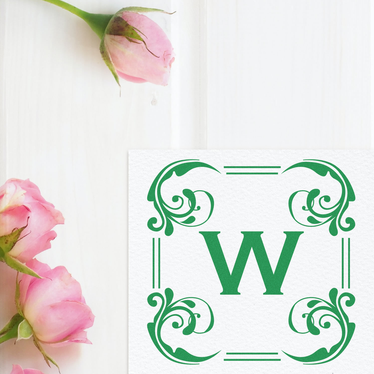 Decorative floral W monogram rubber stamp design with pink roses and ornate green border for personalized stationery.