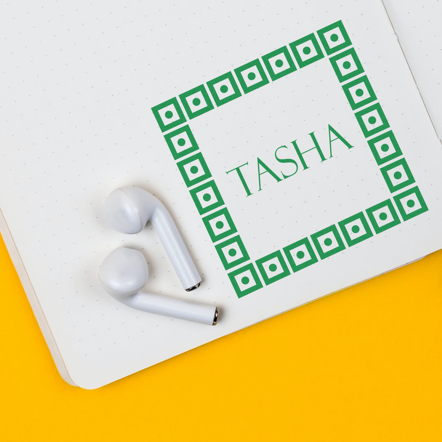 Notebook cover with green TASHIA branding and white earbuds on desk, promoting study notes and audio learning for students.