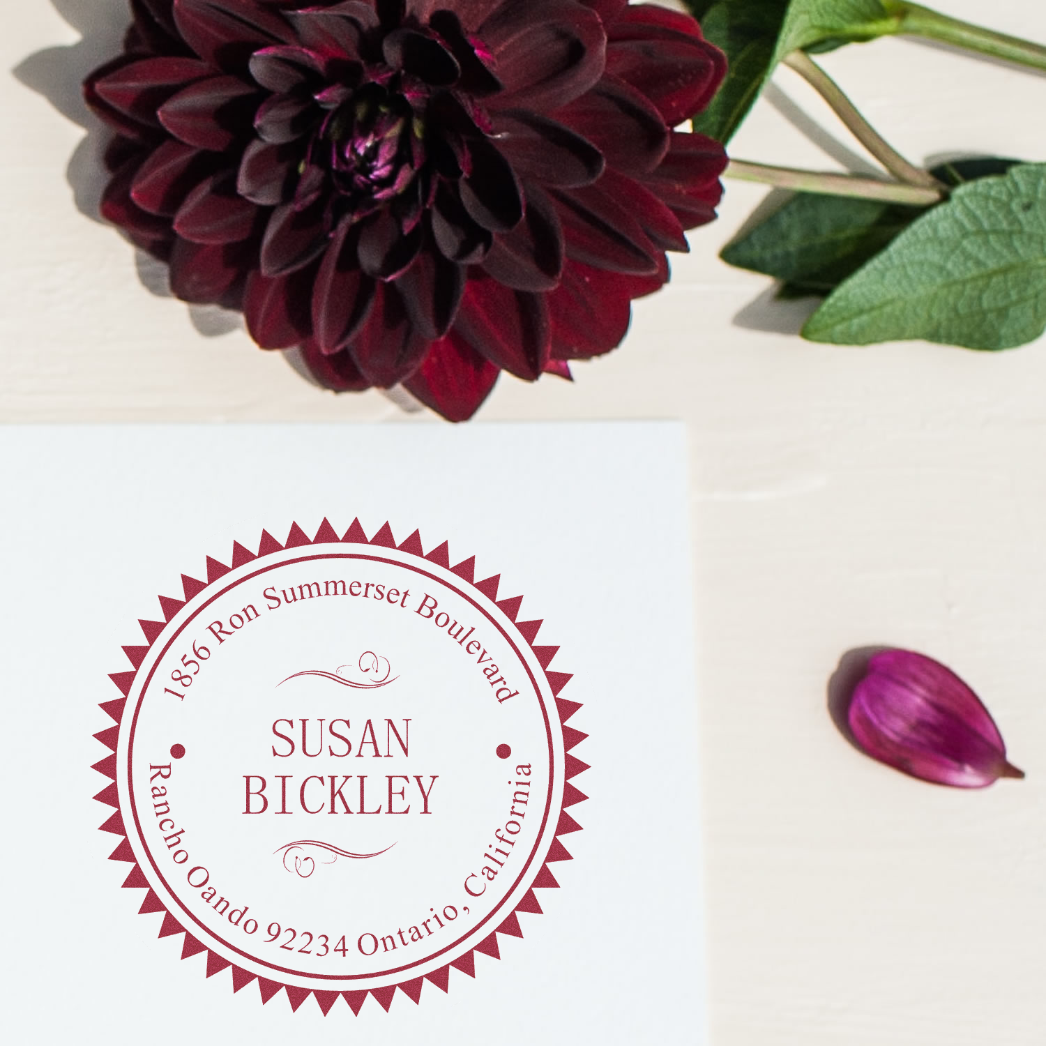 Personalized floral return address rubber stamp for Susan Bickley, featuring a custom round name-and-address design.