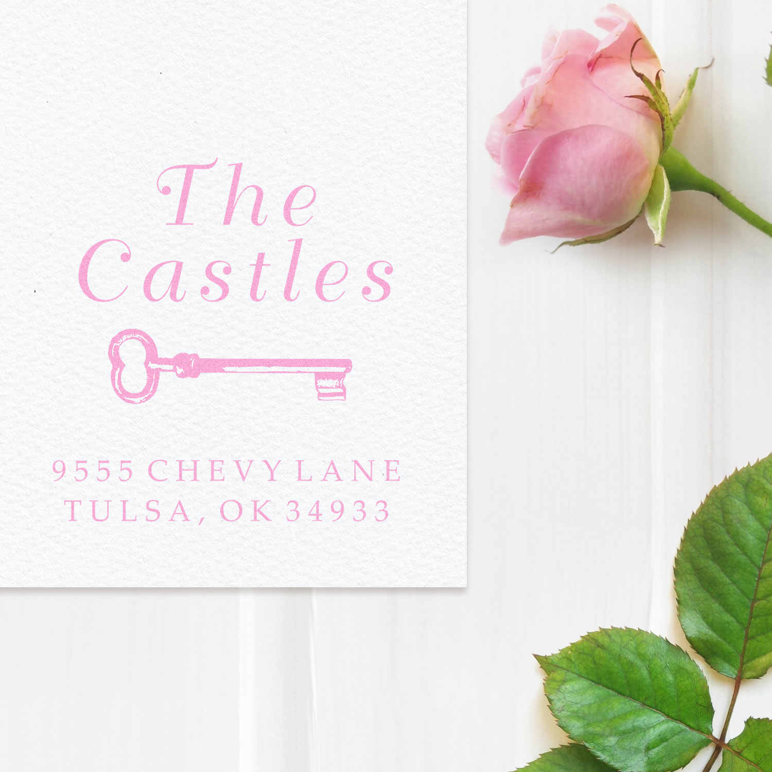 Pink personalized return address rubber stamp with key design for The Castles, 955 Chevy Lane, Tulsa, OK 34933.
