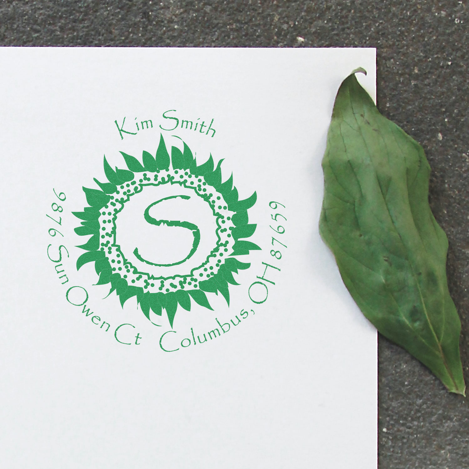 Kim Smith campaign card with green leaf wreath logo and Connect Columbus lettering, with a large green leaf on the side.