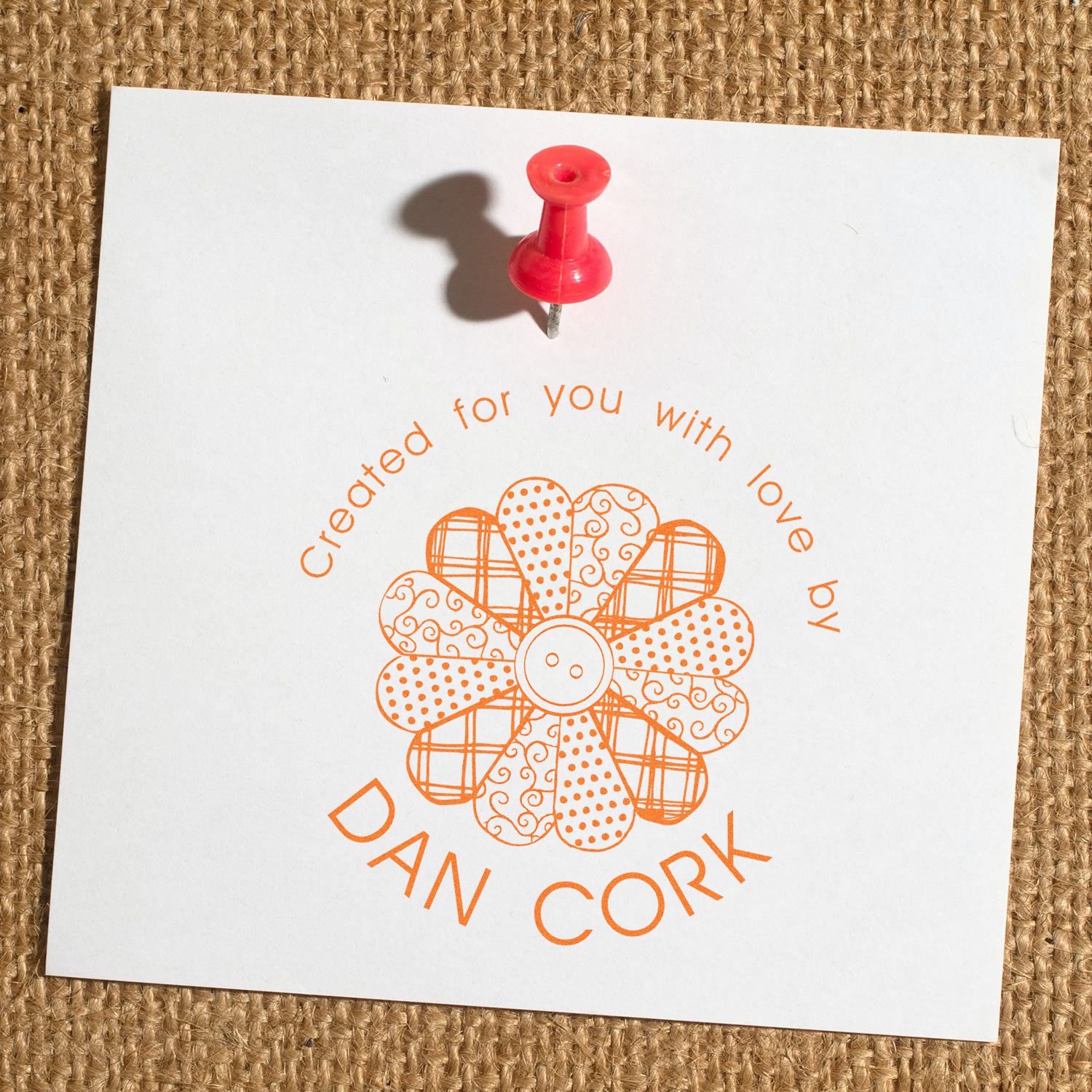 Personalized rubber stamp impression with floral design and Created for you with love by Dan Cork text on white paper.