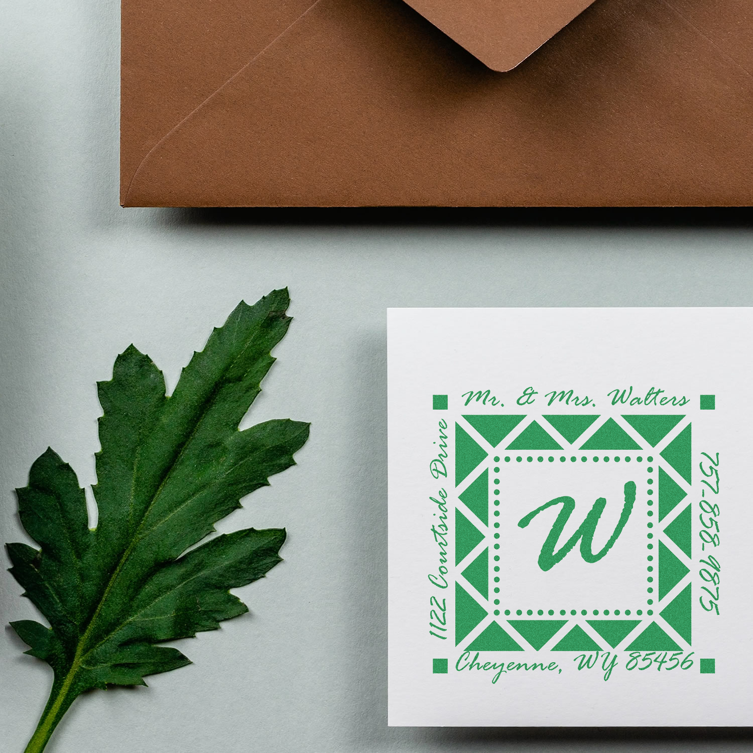 Custom wedding return address rubber stamp with monogram, name, and Cheyenne, WY address on stationery.