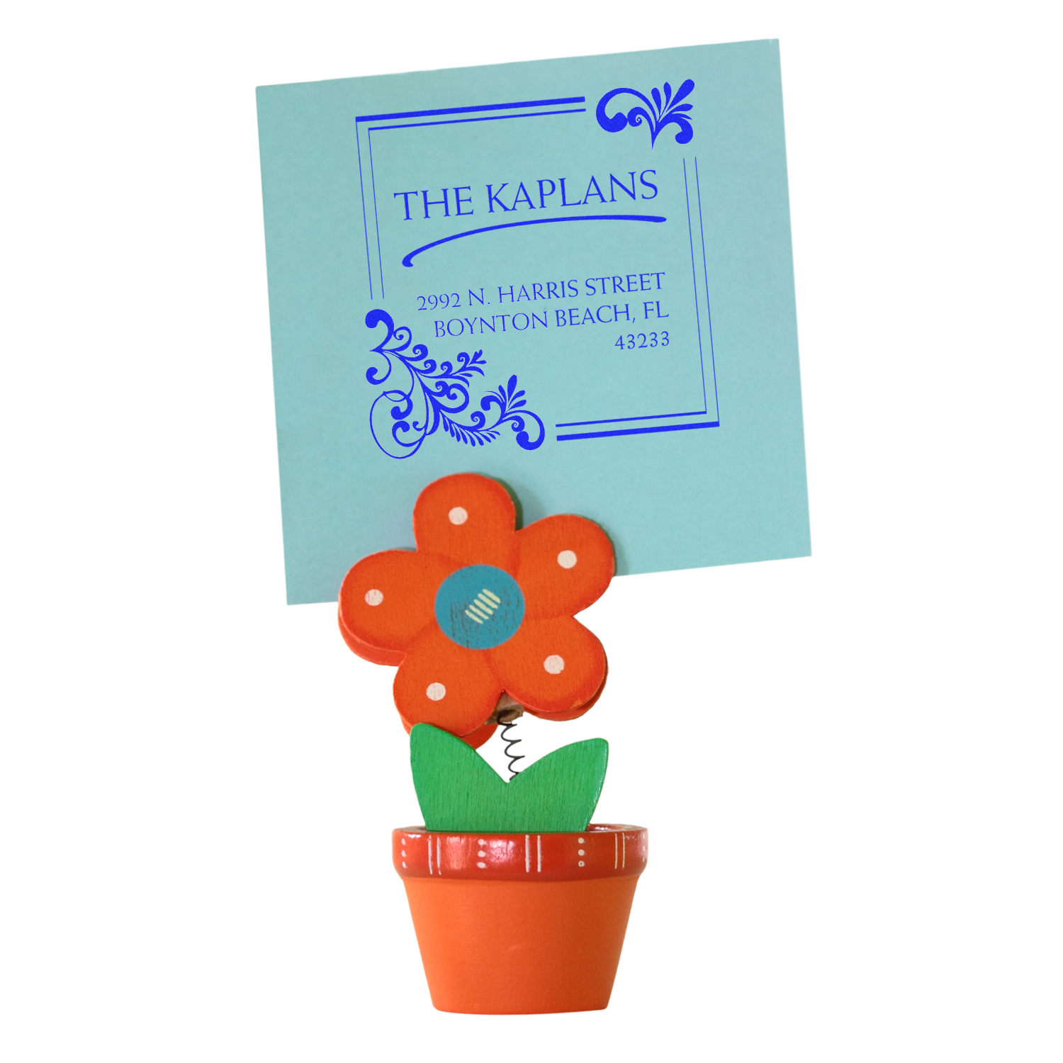Custom floral rubber address stamp for The Kaplans, showing blue return address imprint on a card.