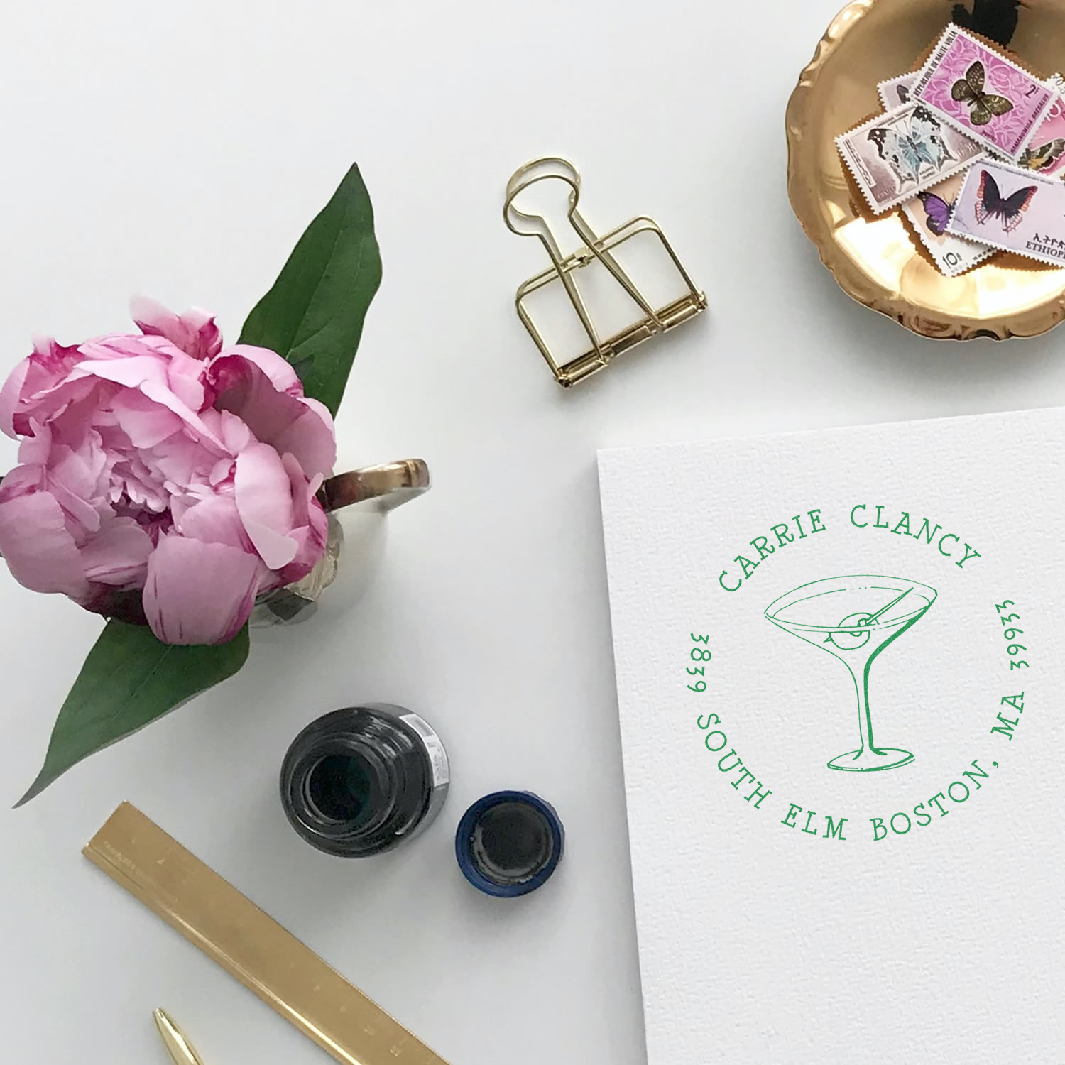 Custom martini rubber stamp with name and location, shown on paper with ink for personalized branding and stationery use.
