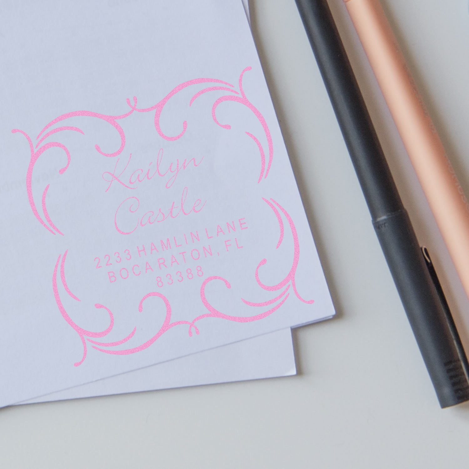 Custom pink rubber address stamp with ornate monogram for Kailyn Castle, showing Boca Raton, FL mailing details.