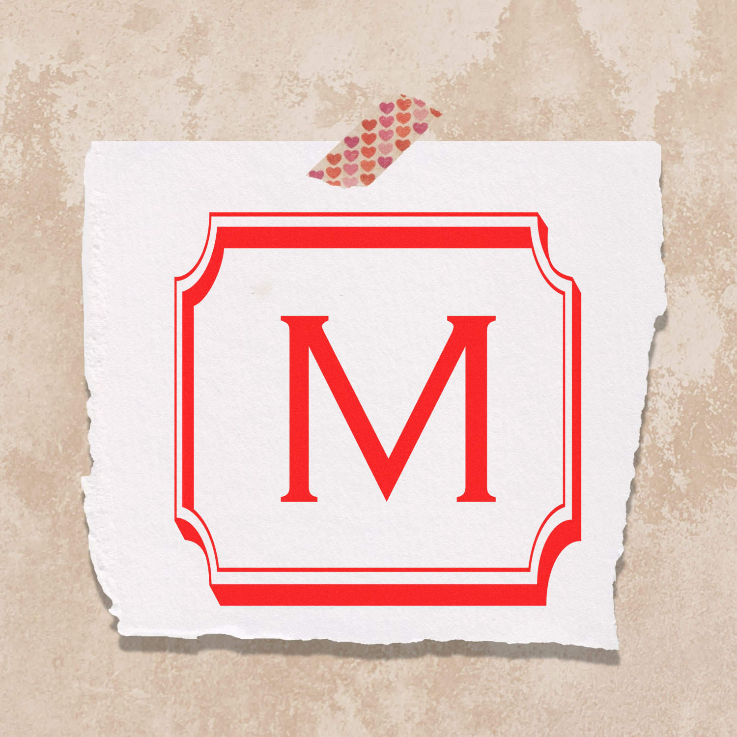 Custom M monogram rubber stamp with red frame, ideal for personalized stationery and branding.