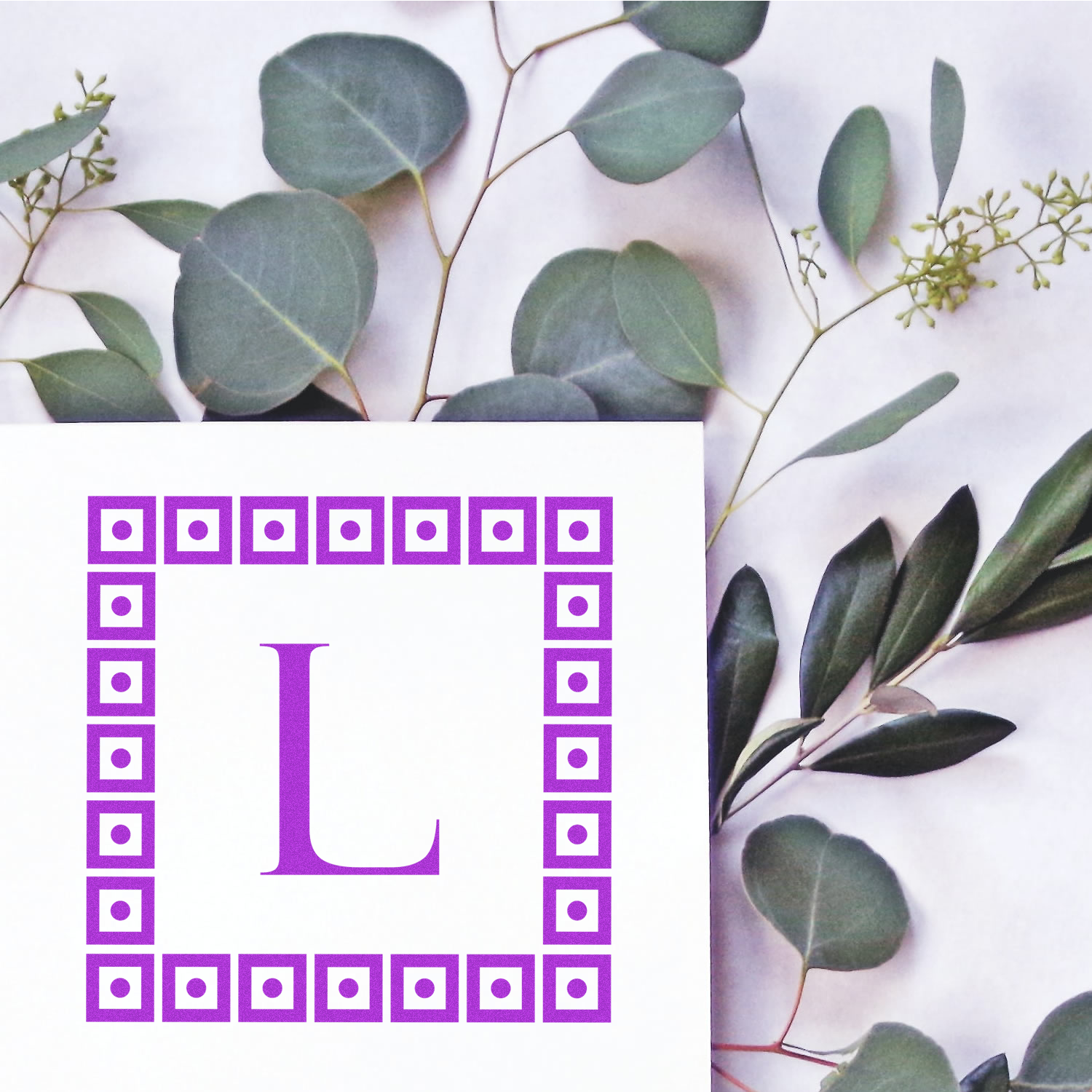 Letter U alphabet graphic with purple border over eucalyptus leaves, botanical typography design for education and branding print