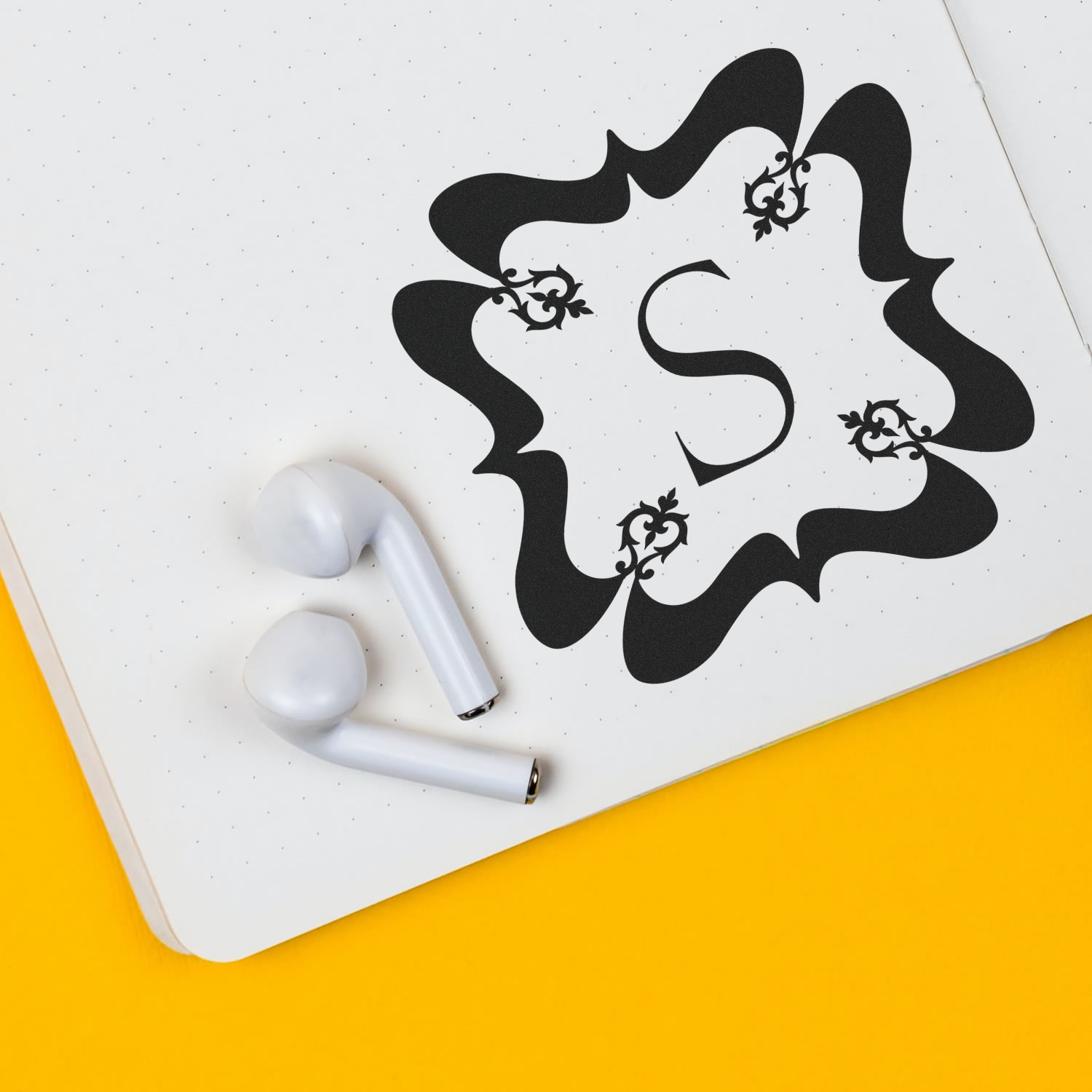 Decorative letter S custom rubber stamp impression on notebook paper for monogram stationery and branding.