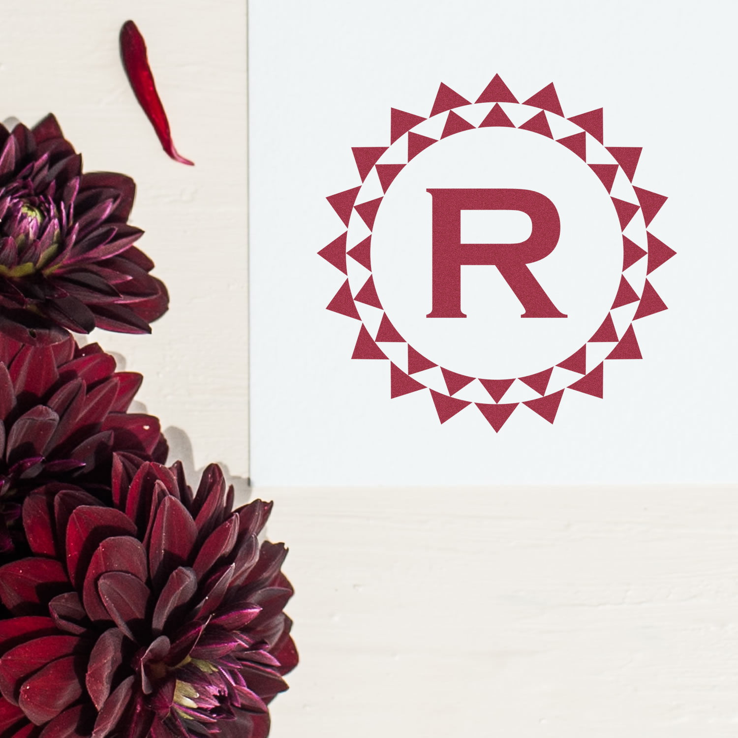 Elegant monogram R rubber stamp with burgundy geometric wreath, ideal for custom branding, invitations, and packaging.