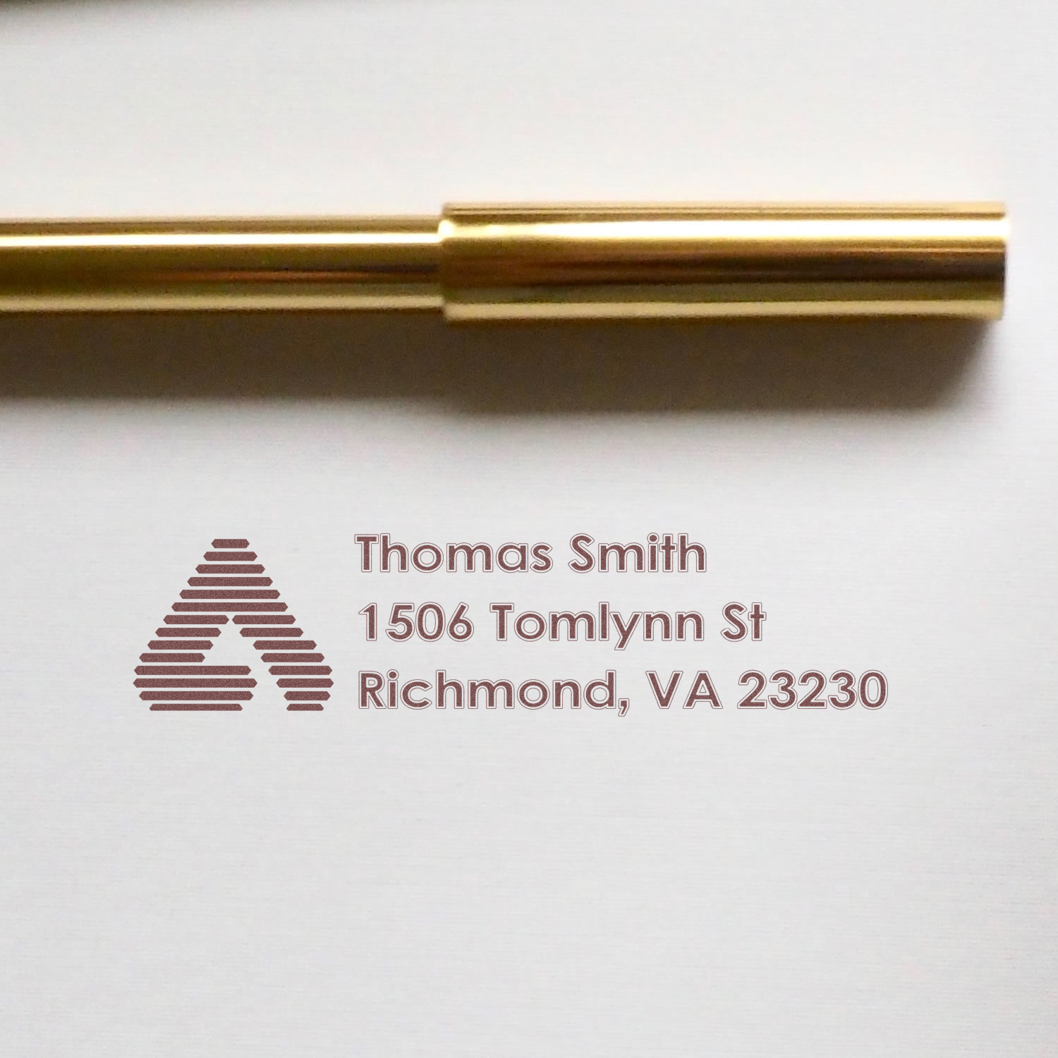 Custom rubber stamp return address design for Thomas Smith, Richmond, VA 23230, with logo