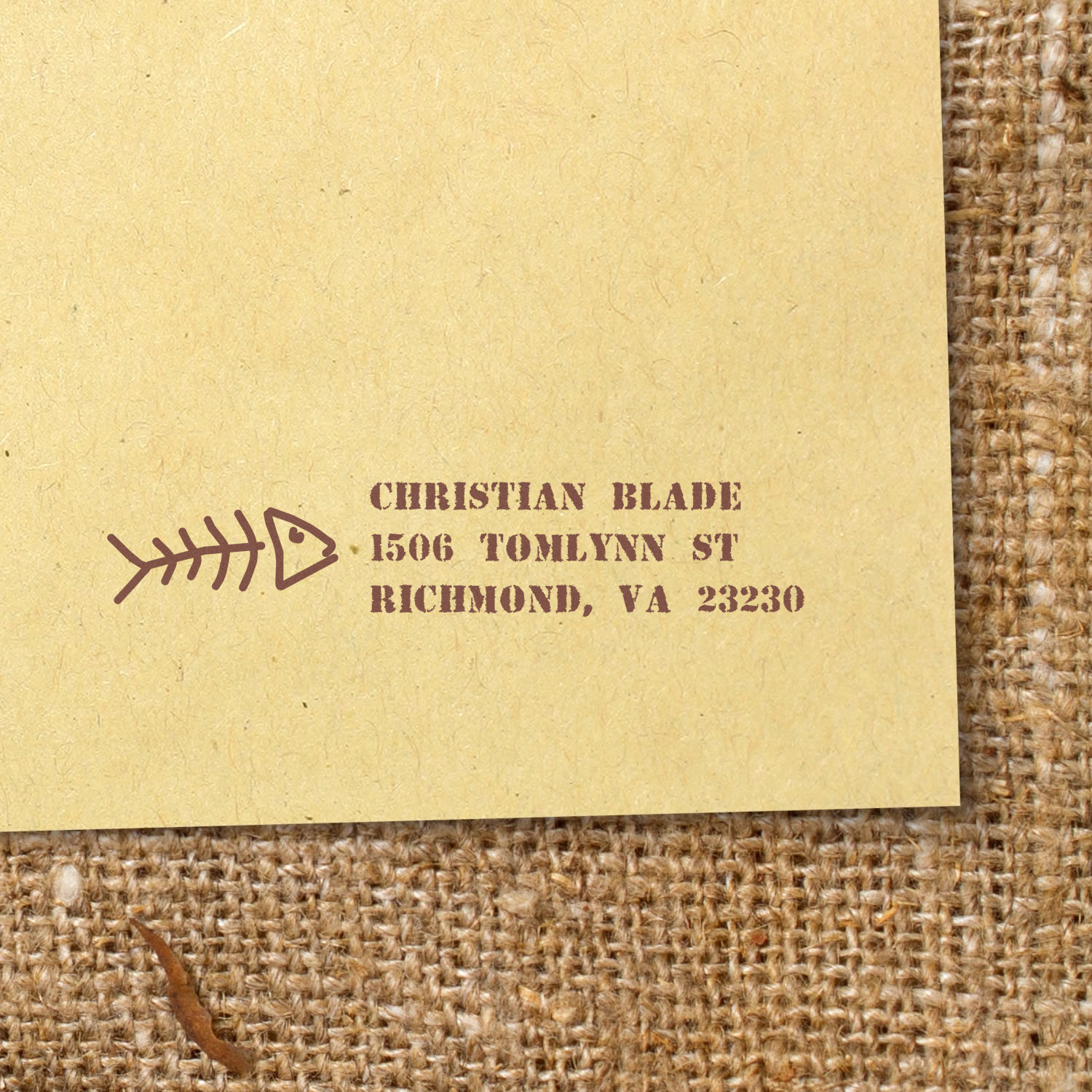 Custom return address rubber stamp with fishbone design stamped on kraft paper for Christian Blade, Richmond, VA.