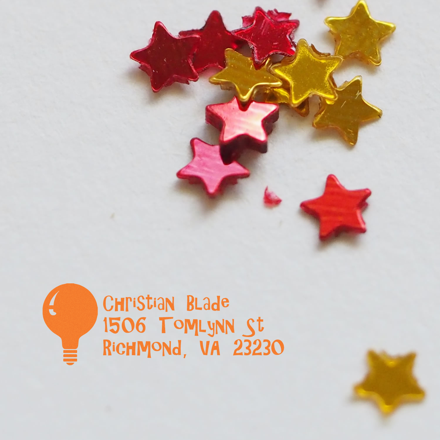 Personalized return address rubber stamp with star confetti design on white paper