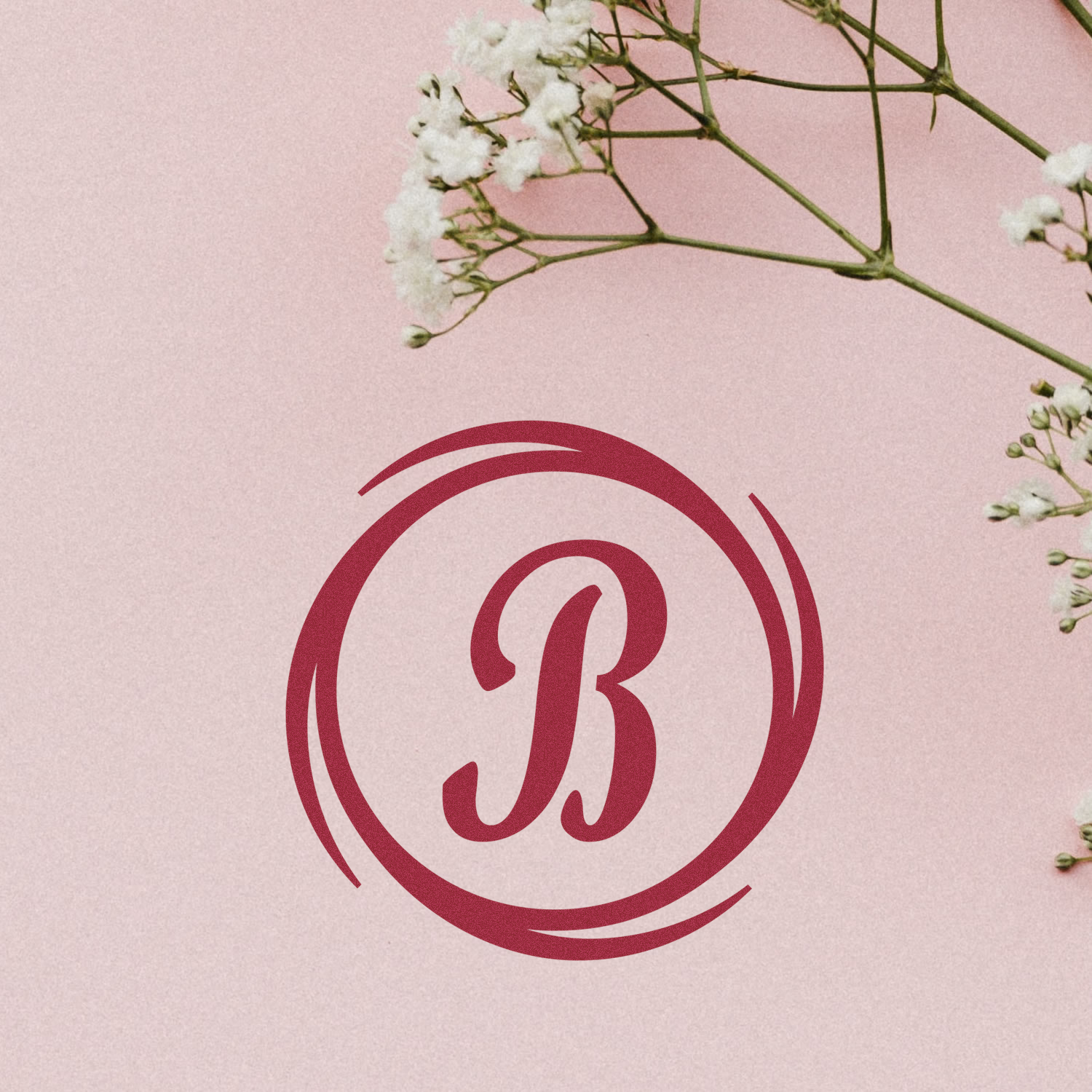 Custom monogram B rubber stamp design with floral babys breath on a blush pink background