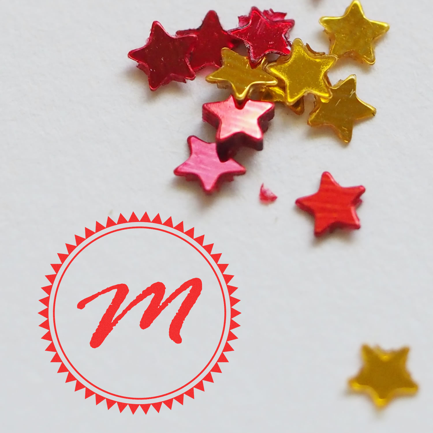 Custom rubber stamp seal sample with colorful star confetti on white background.
