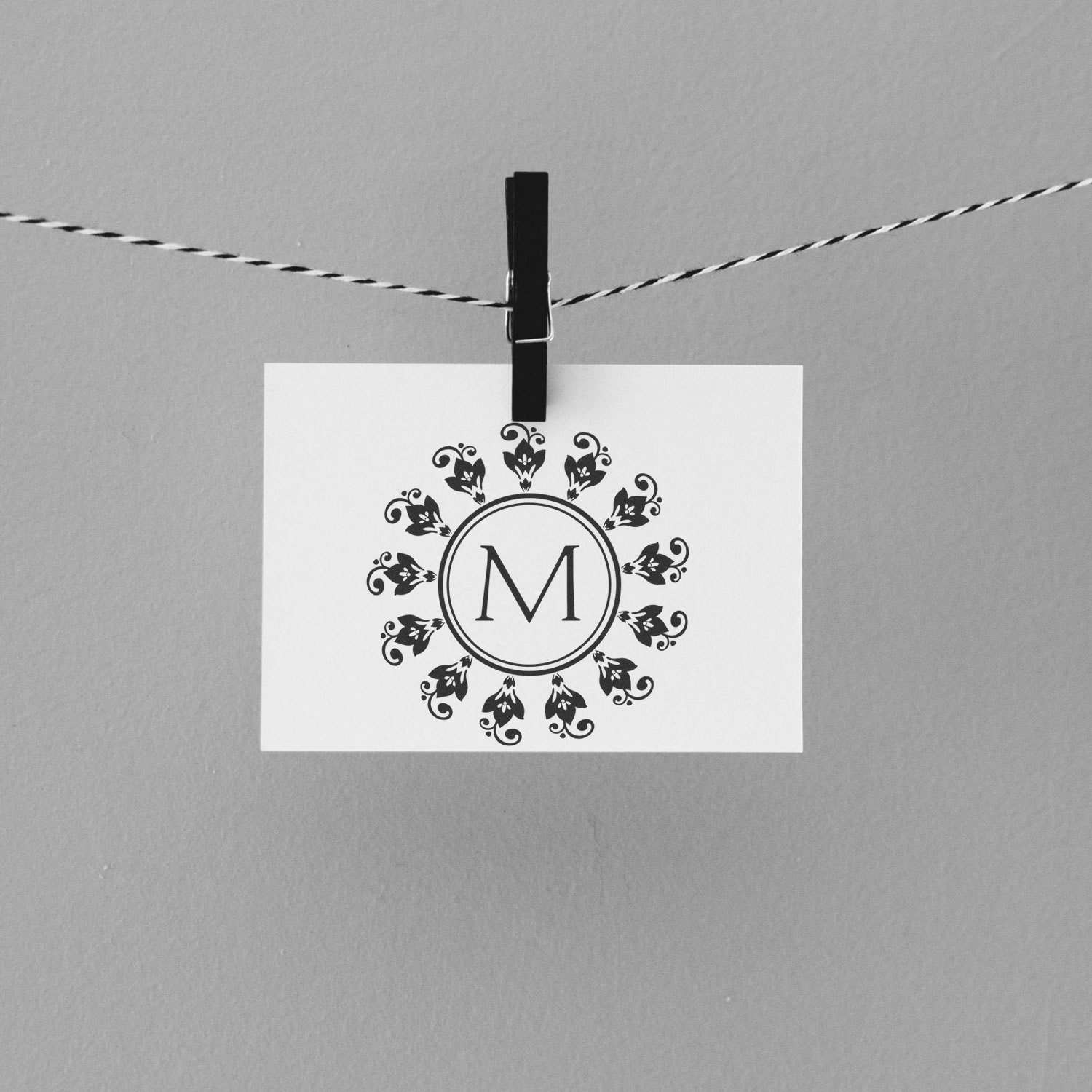 Custom floral monogram rubber stamp with letter M, perfect for wedding invitations, stationery, and personalized packaging.