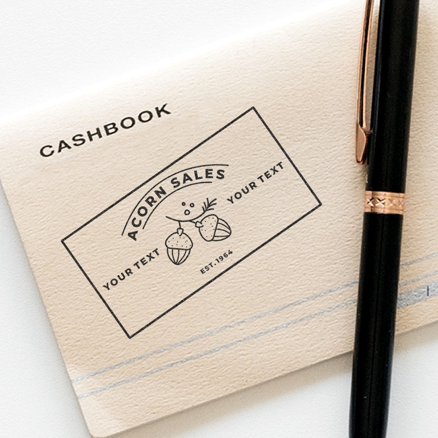Close-up of a customizable cashbook cover design with a sales label and Your Text area, next to a pen.