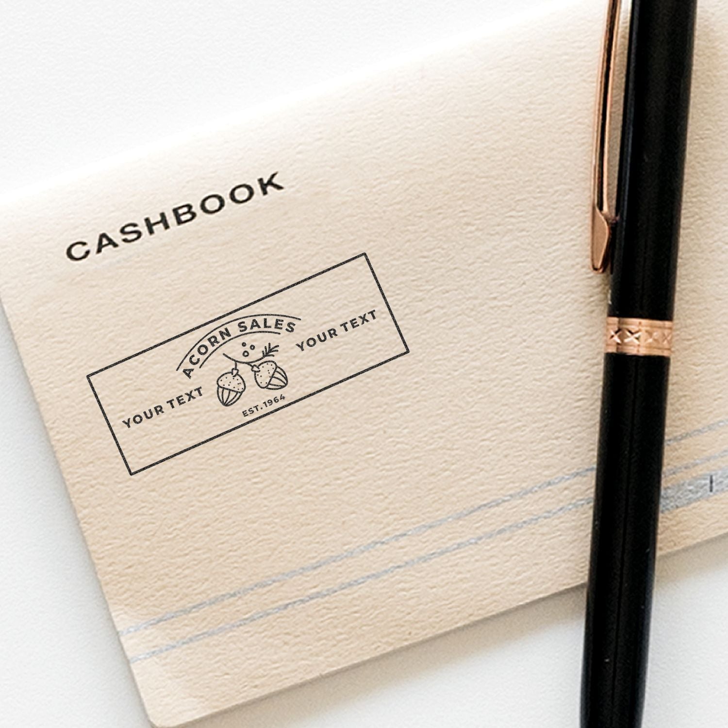 Close-up of branded cashbook with custom OR N SALES label, Est. 1964, and Your Text beside a pen.