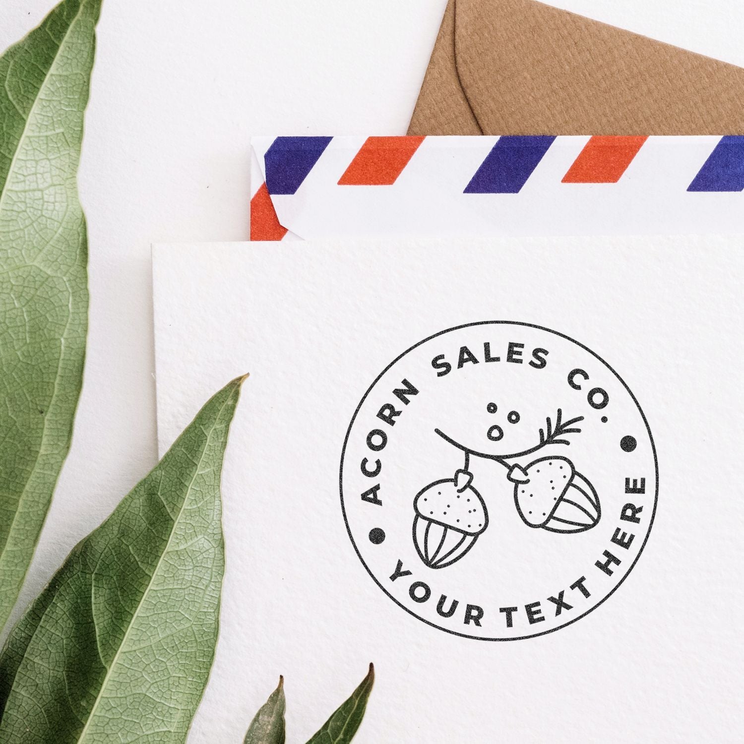 Eco-friendly branded envelope and stationery mockup with acorn logo, green leaves, and custom mail design template.