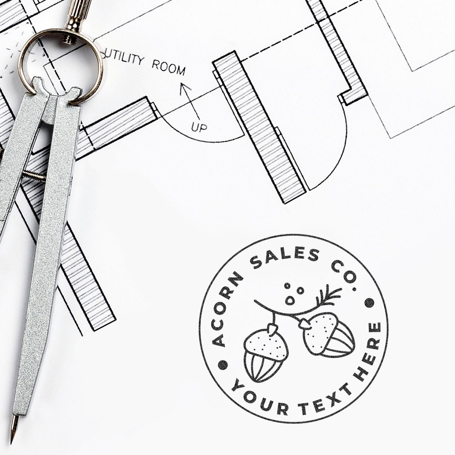 Architectural blueprint floor plan with drafting compass and custom acorn logo branding mockup.