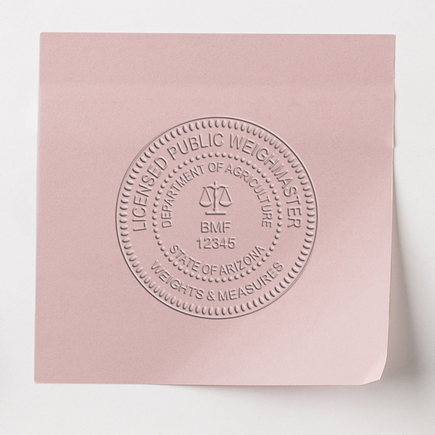 Pink licensed public weighmaster certificate booklet with embossed State of Arizona Department of Agriculture seal.