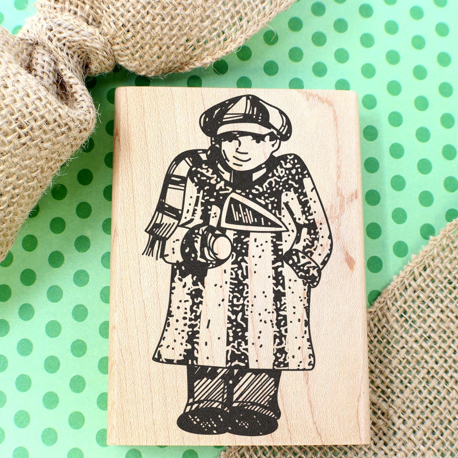 Wooden stamp block featuring a vintage child illustration on a green polka dot background with burlap fabric.