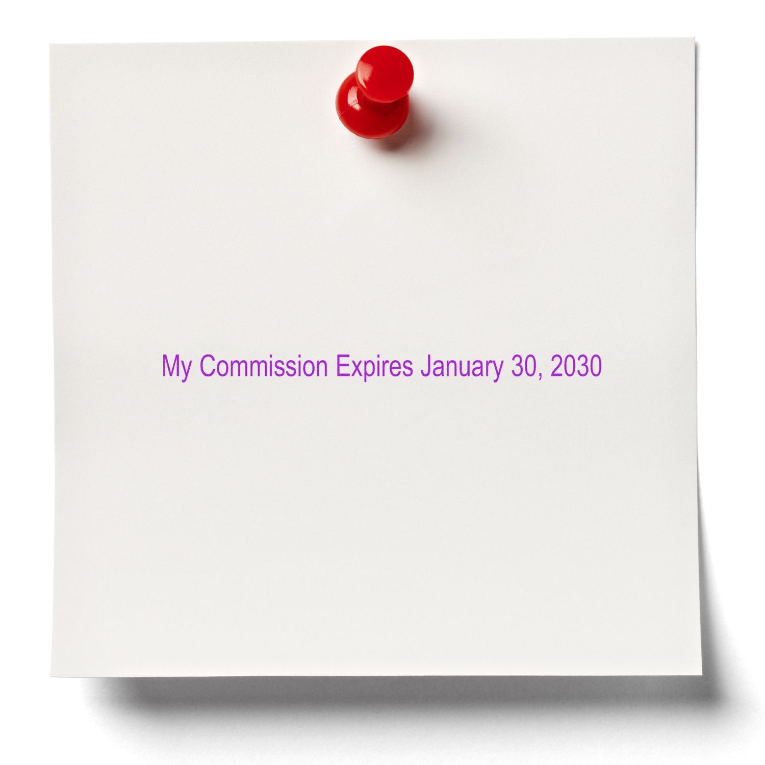 White note card pinned with a red pushpin reading My Commission Expires January 30, 2030 in purple text.