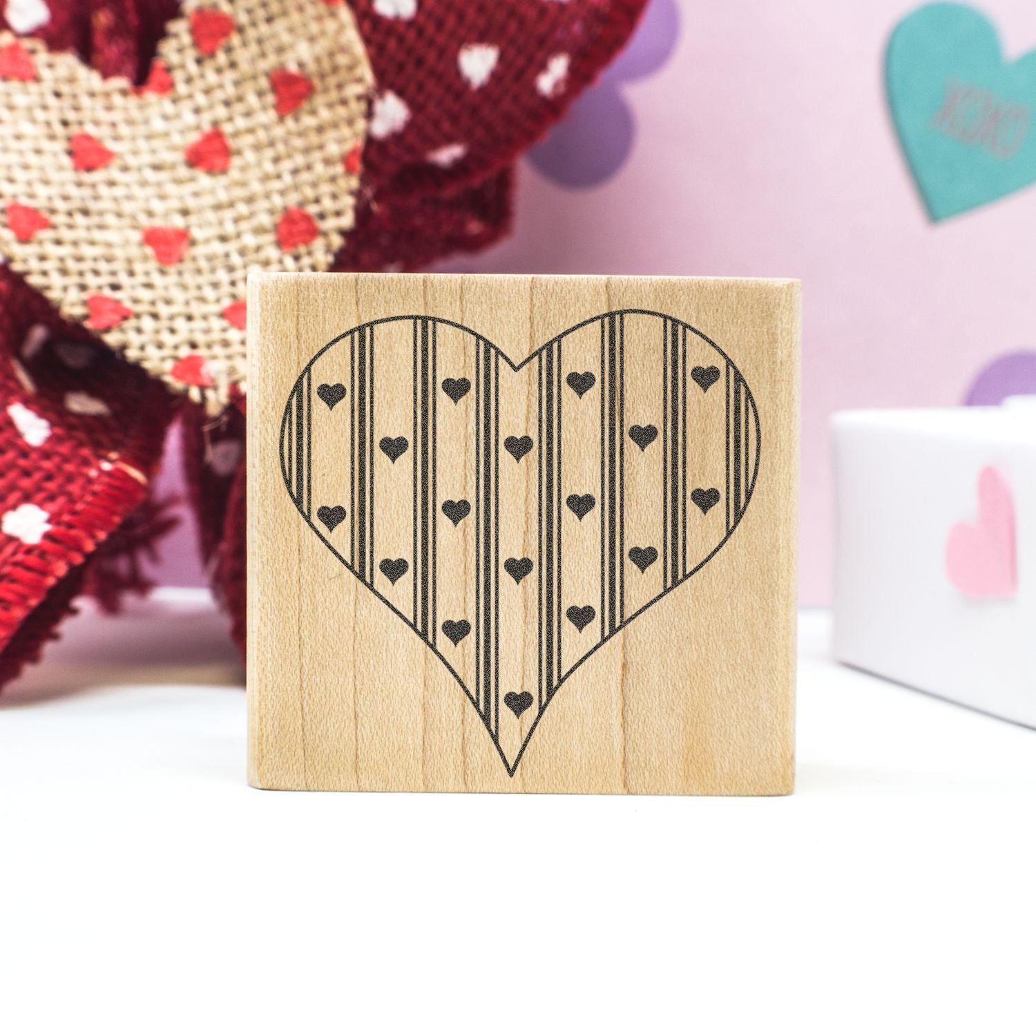 Wooden heart stamp block with striped heart pattern, romantic Valentines Day craft decor.