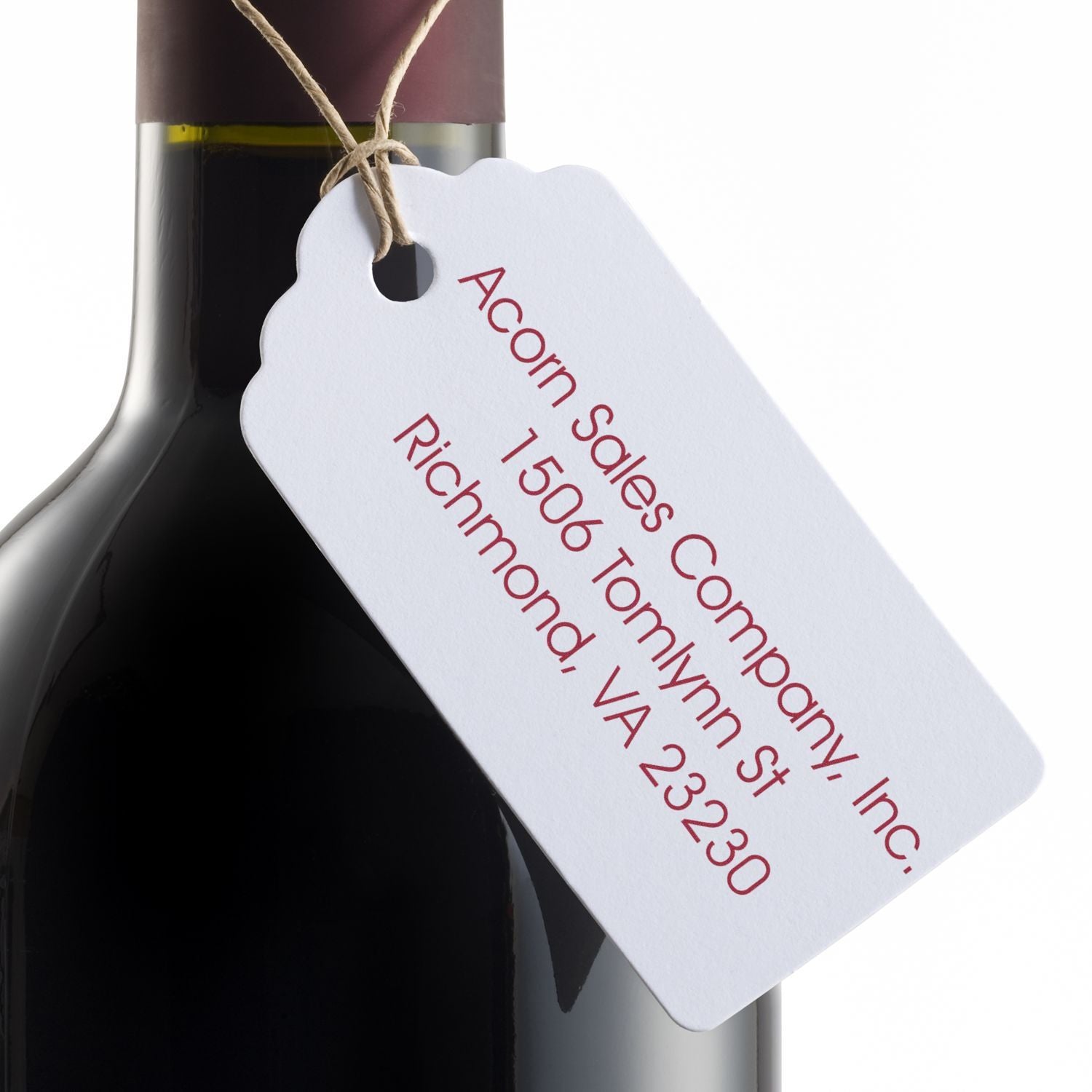 Custom rubber stamp wine bottle tag with business address for branded packaging and gift presentation.
