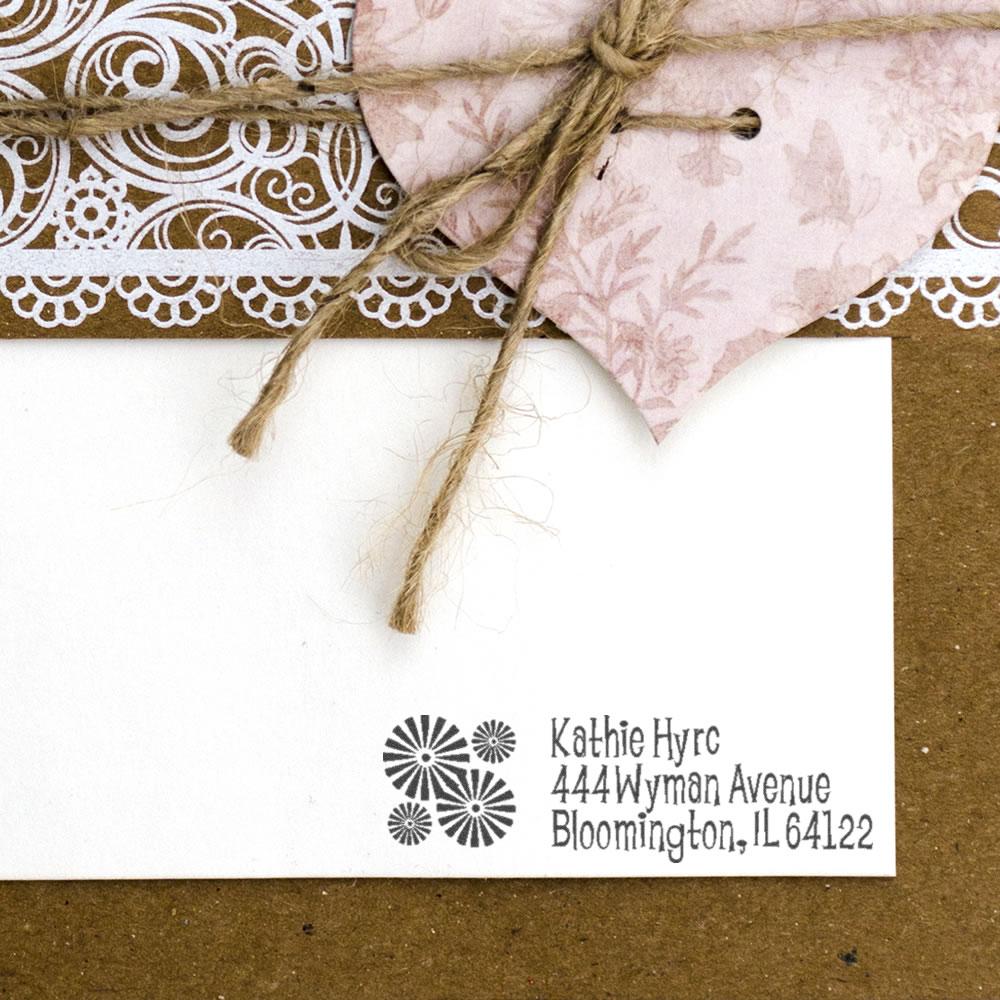 Custom address rubber stamp on handmade stationery with twine, lace trim, and floral paper accents.