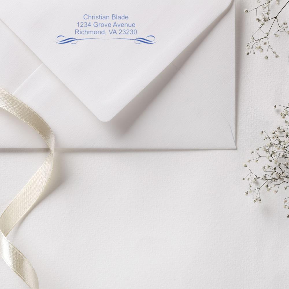 Custom return address rubber stamp on white envelope for wedding invitations and elegant stationery.