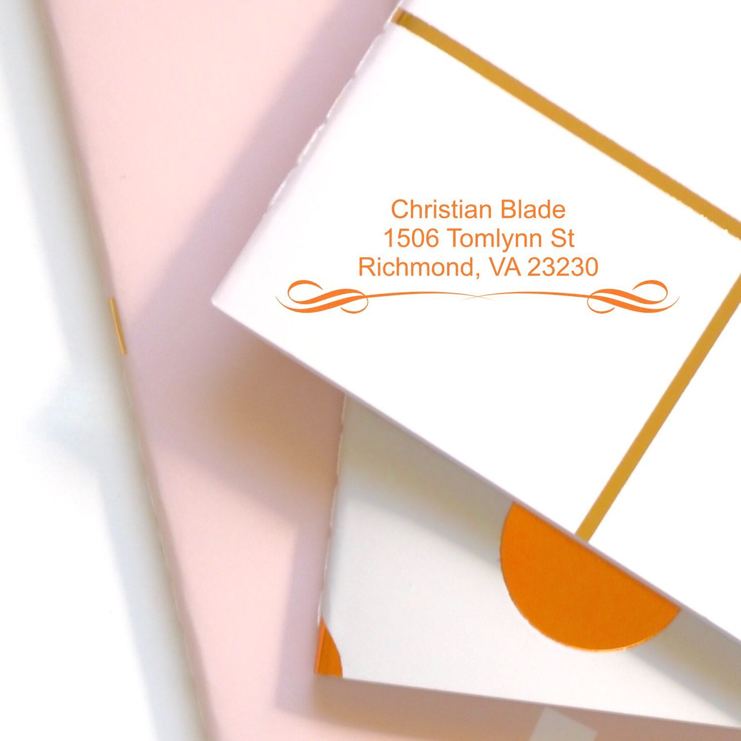 Custom return address rubber stamp for Christian Blade, Richmond, VA 23230, on white stationery with orange envelope design