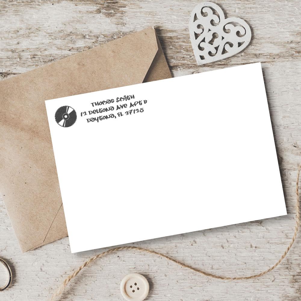 Custom return address rubber stamp on a plain envelope, ideal for handmade stationery and small business mailing.