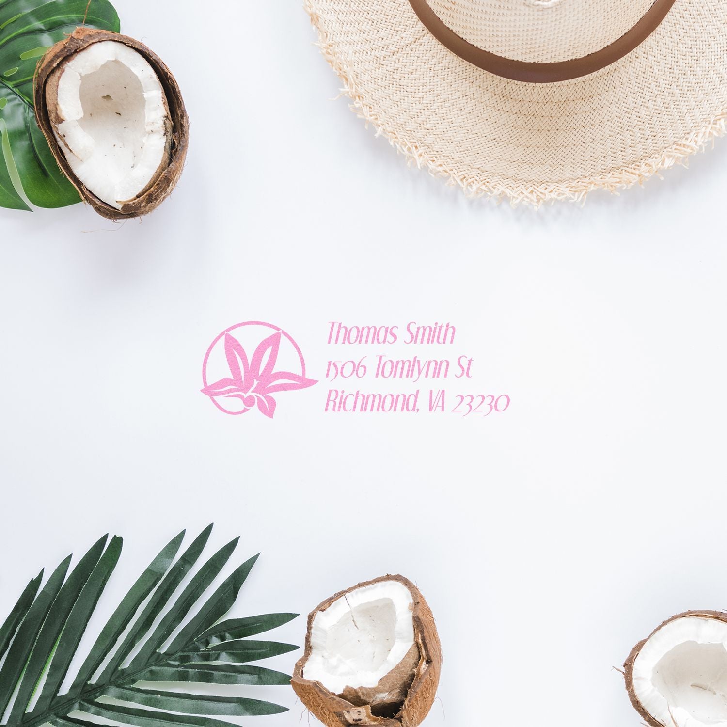 Custom return address rubber stamp with pink floral design on white paper, styled with tropical coconuts and palm leaves.